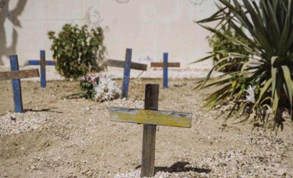 Auf vielen Gräbern dieses Friedhofs auf der italienischen Insel Lampedusa sind schlichte Holzkreuze mit verblasster Farbe die einzigen Grabsteine